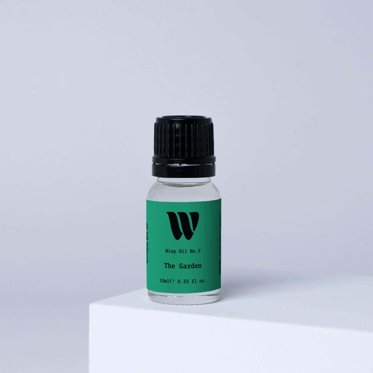 Bottle of the 10ml Wisp home fragrance oil No.9 The Garden which has notes of lotus blossom and water lily.