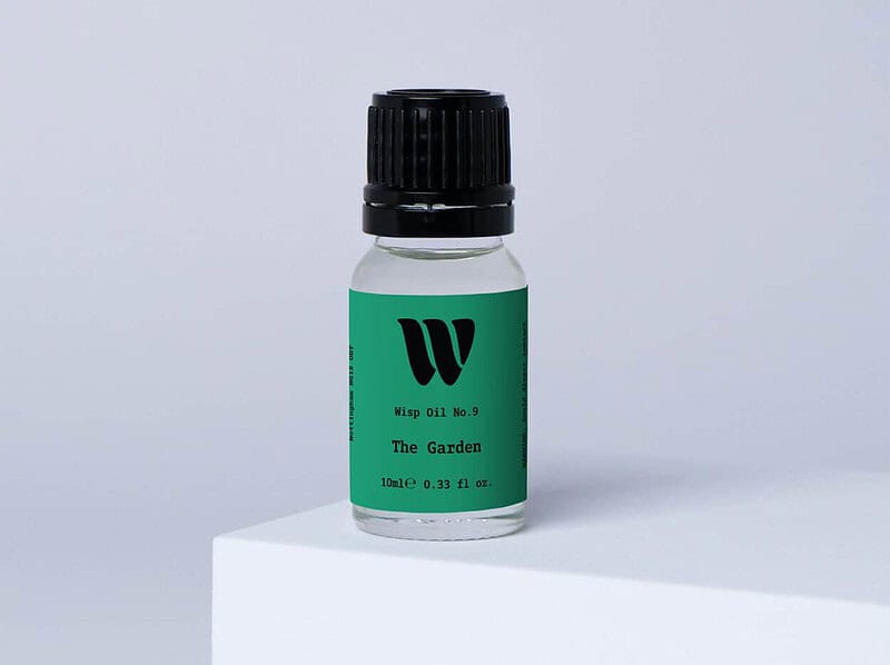 Bottle of the 10ml Wisp home fragrance oil No.9 The Garden which has notes of lotus blossom and water lily.