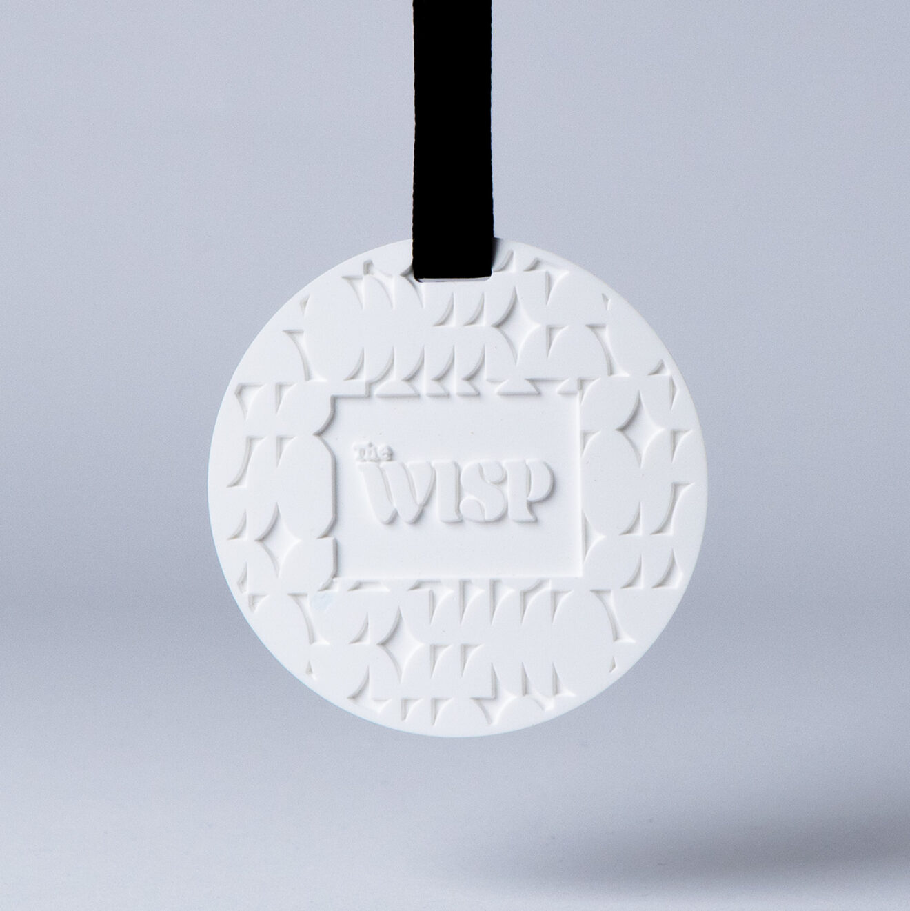 Premium wisp branded essential oil fragrance stone to hang in car or wardrobe.
