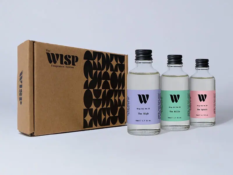 The Pastel Trio gift set by The Wisp — three 50ml home fragrance oils, The Spirit, The Hills and The High, beside the kraft gift box
