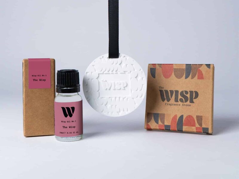 Bottle of the 10ml Wisp home fragrance oil No.1 The Wisp which has notes of amber, jasmine, coconut and bergamot, with a premium wisp branded fragrance stone to hang in car or wardrobe. The perfect small gift.