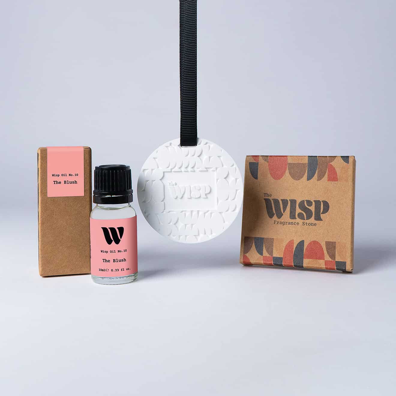 Bottle of the 10ml Wisp home fragrance oil No.10 The Blush which has notes of red apple, peony and jasmine, with a premium wisp branded fragrance stone to hang in car or wardrobe. The perfect small gift.