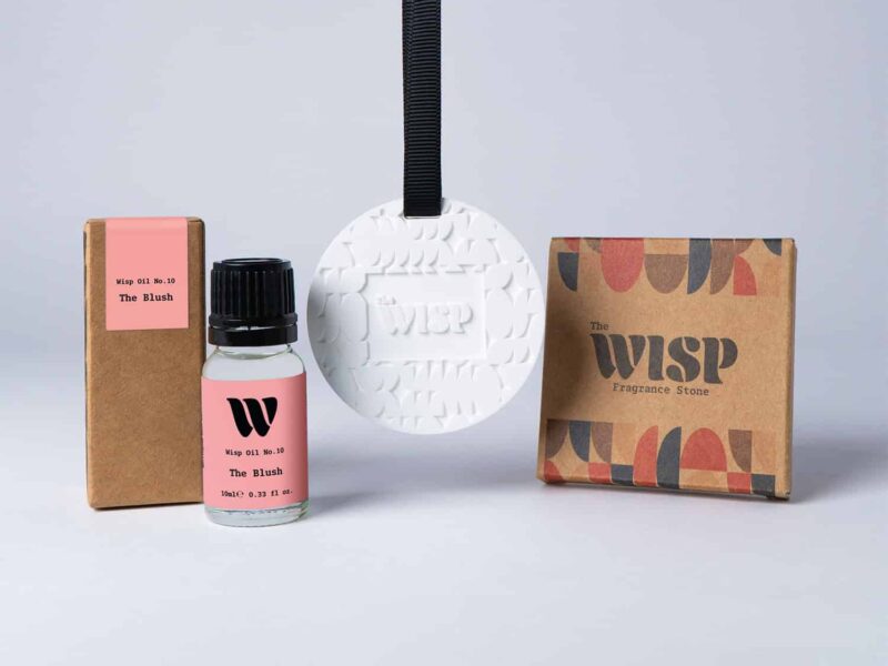 Bottle of the 10ml Wisp home fragrance oil No.10 The Blush which has notes of red apple, peony and jasmine, with a premium wisp branded fragrance stone to hang in car or wardrobe. The perfect small gift.