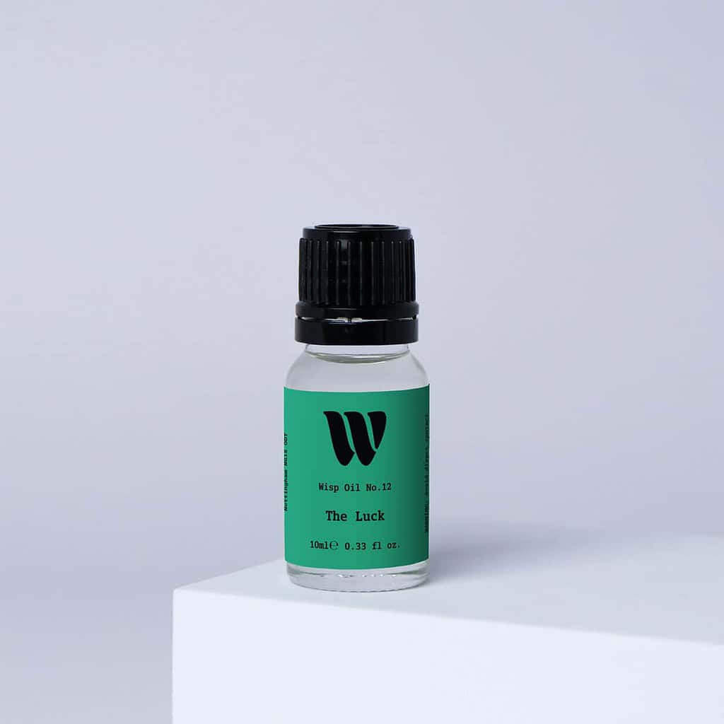 Bottle of the 10ml Wisp home fragrance oil No.12 The Luck which has notes of amber, clover and ivy.