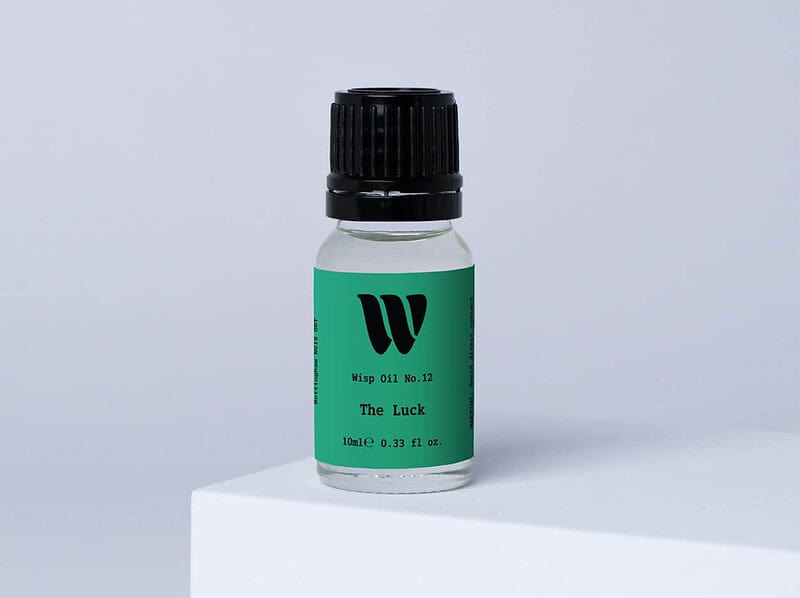 Bottle of the 10ml Wisp home fragrance oil No.12 The Luck which has notes of amber, clover and ivy.