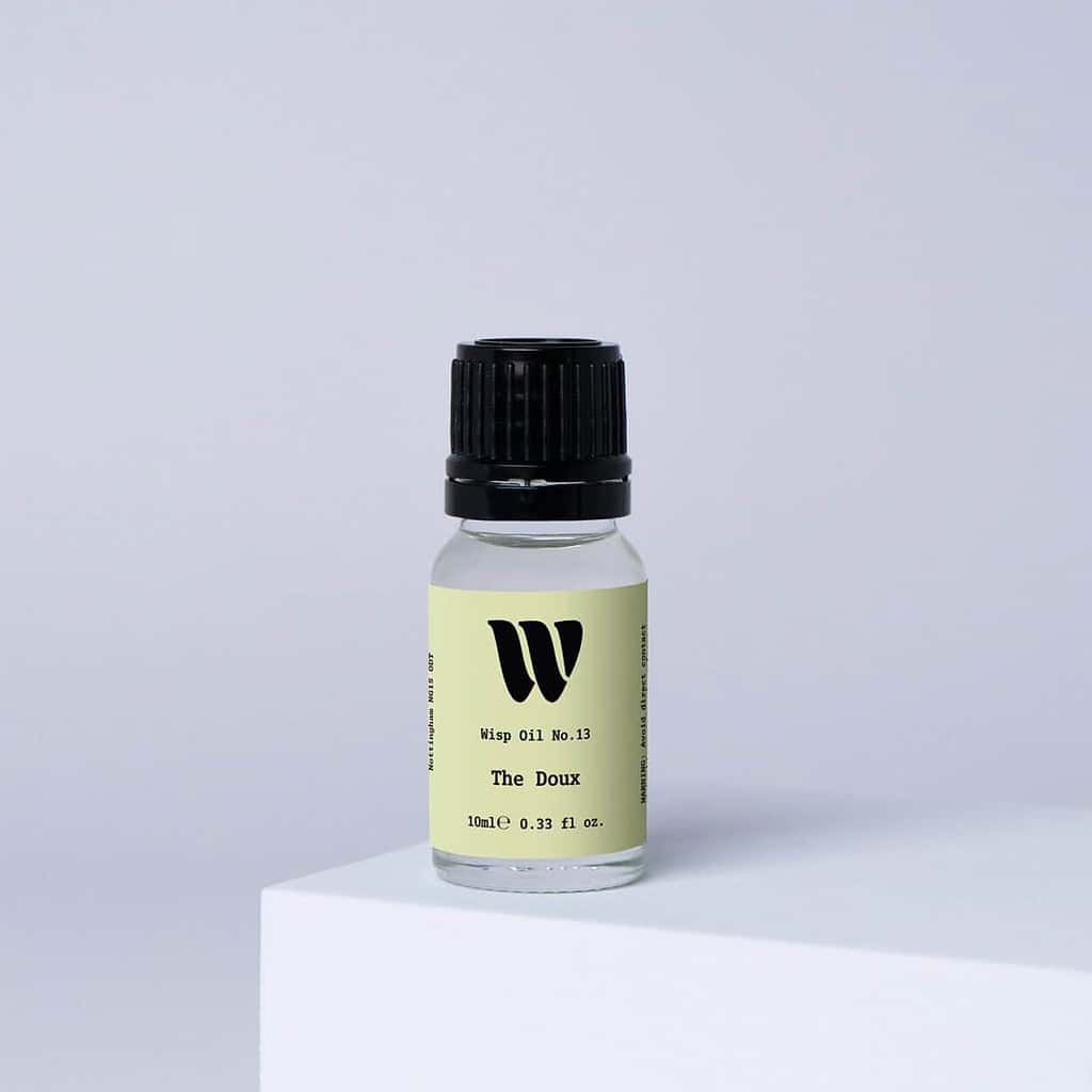 Bottle of the 10ml Wisp home fragrance oil No.13 The Doux which has notes of lush rose, carnation, and ylang-ylang.