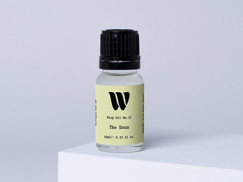 Bottle of the 10ml Wisp home fragrance oil No.13 The Doux which has notes of lush rose, carnation, and ylang-ylang.