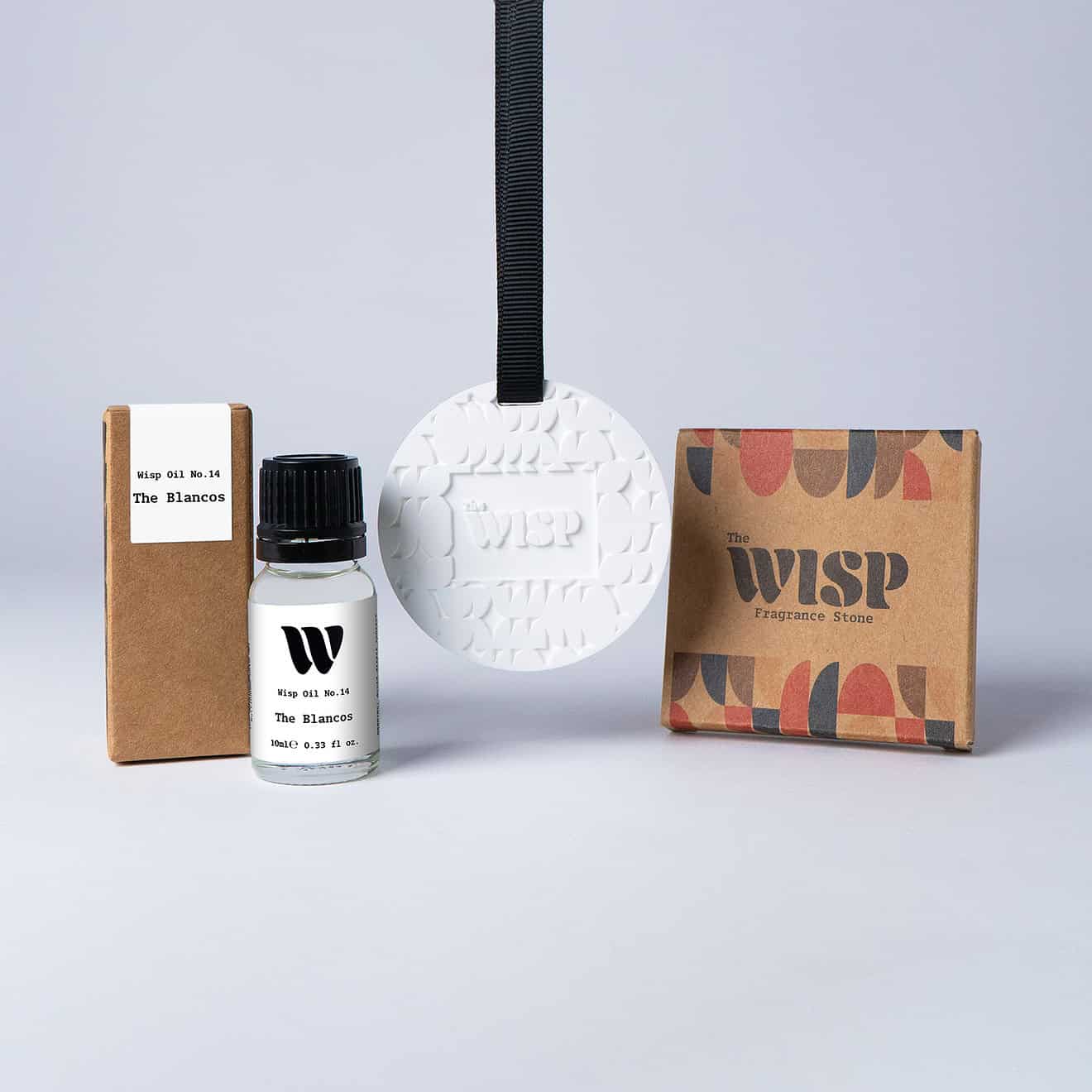 Bottle of the 10ml Wisp home fragrance oil No.14 The Blancos which has notes of soft violet and magnolia, with a premium wisp branded fragrance stone to hang in car or wardrobe. The perfect small gift.