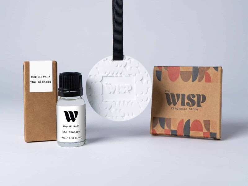 Bottle of the 10ml Wisp home fragrance oil No.14 The Blancos which has notes of soft violet and magnolia, with a premium wisp branded fragrance stone to hang in car or wardrobe. The perfect small gift.