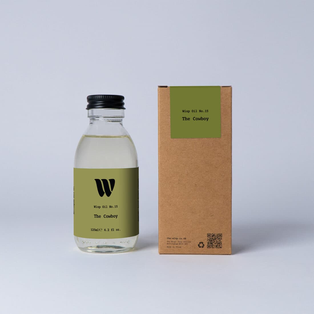 Bottle of the 125ml Wisp home fragrance oil No.15 The Cowboy which has notes of sandalwood and cedarwood.