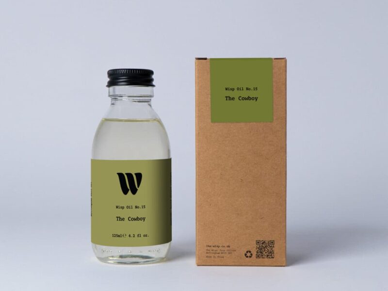 Bottle of the 125ml Wisp home fragrance oil No.15 The Cowboy which has notes of sandalwood and cedarwood.