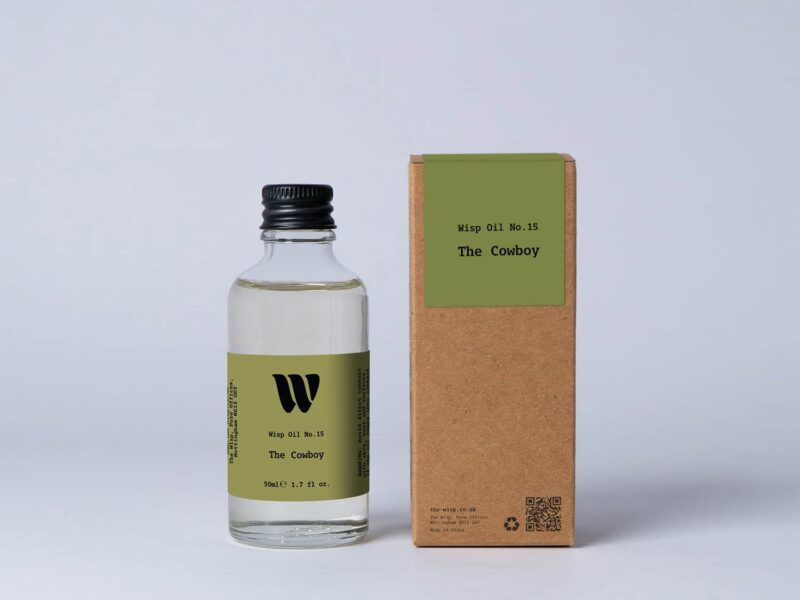 Bottle of the 50ml Wisp home fragrance oil No.15 The Cowboy which has notes of sandalwood and cedarwood.