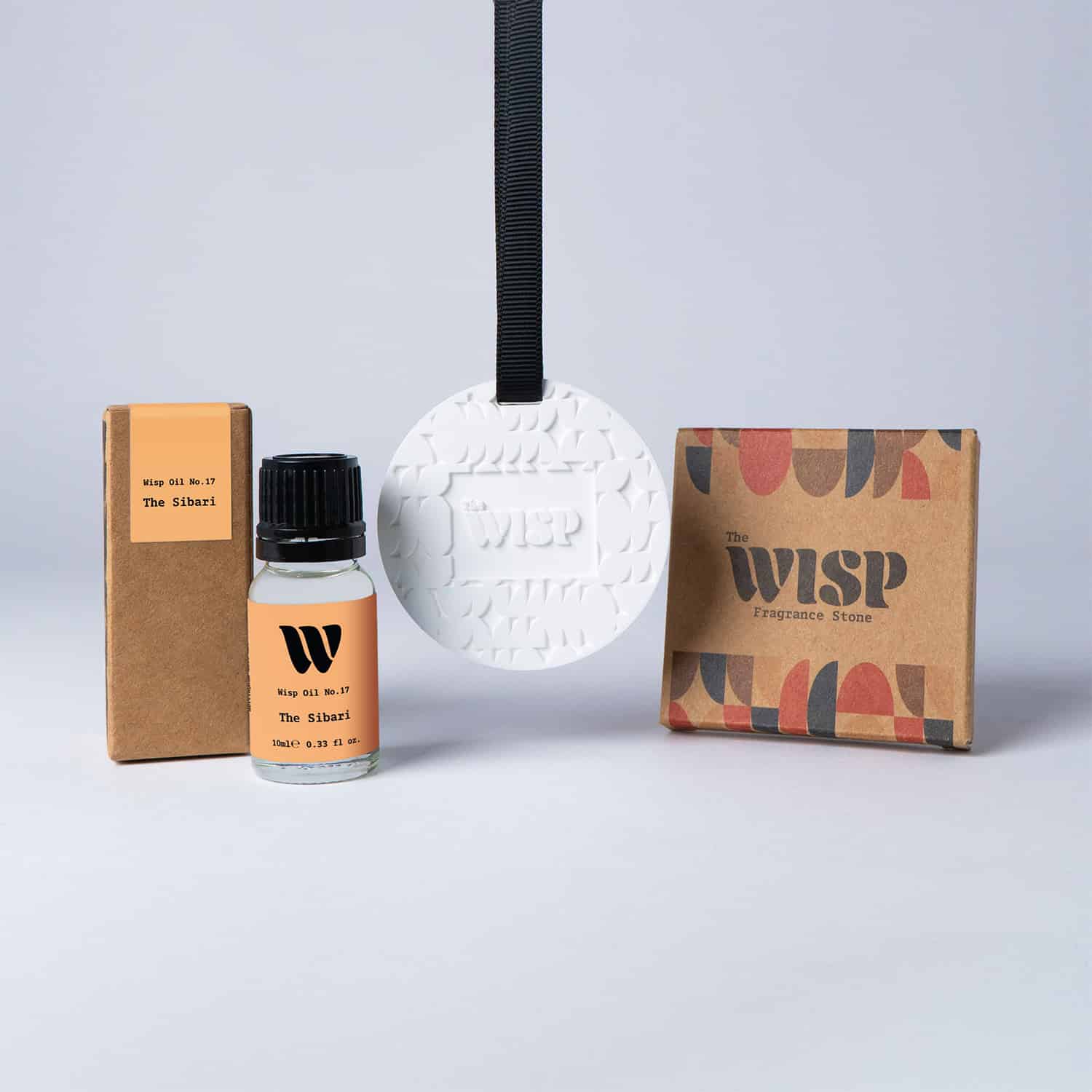 Bottle of the 10ml Wisp home fragrance oil No.17 The Sibari which has notes of orange and citrus, with a premium wisp branded fragrance stone to hang in car or wardrobe. The perfect small gift.