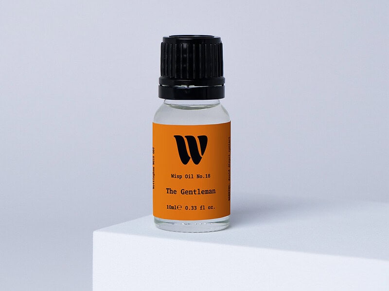 Bottle of the 10ml Wisp home fragrance oil No.18 The Gentleman which has notes of saffron, raspberry, and thyme.