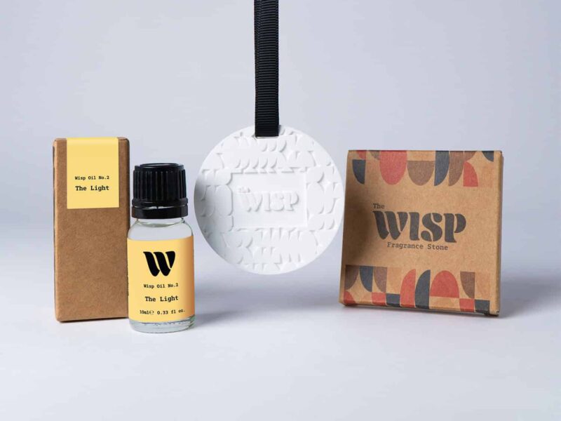 Bottle of the 10ml Wisp home fragrance oil No.2 The Light which has notes of citrus, fresh grass and ocean breeze, with a premium wisp branded fragrance stone to hang in car or wardrobe. The perfect small gift.