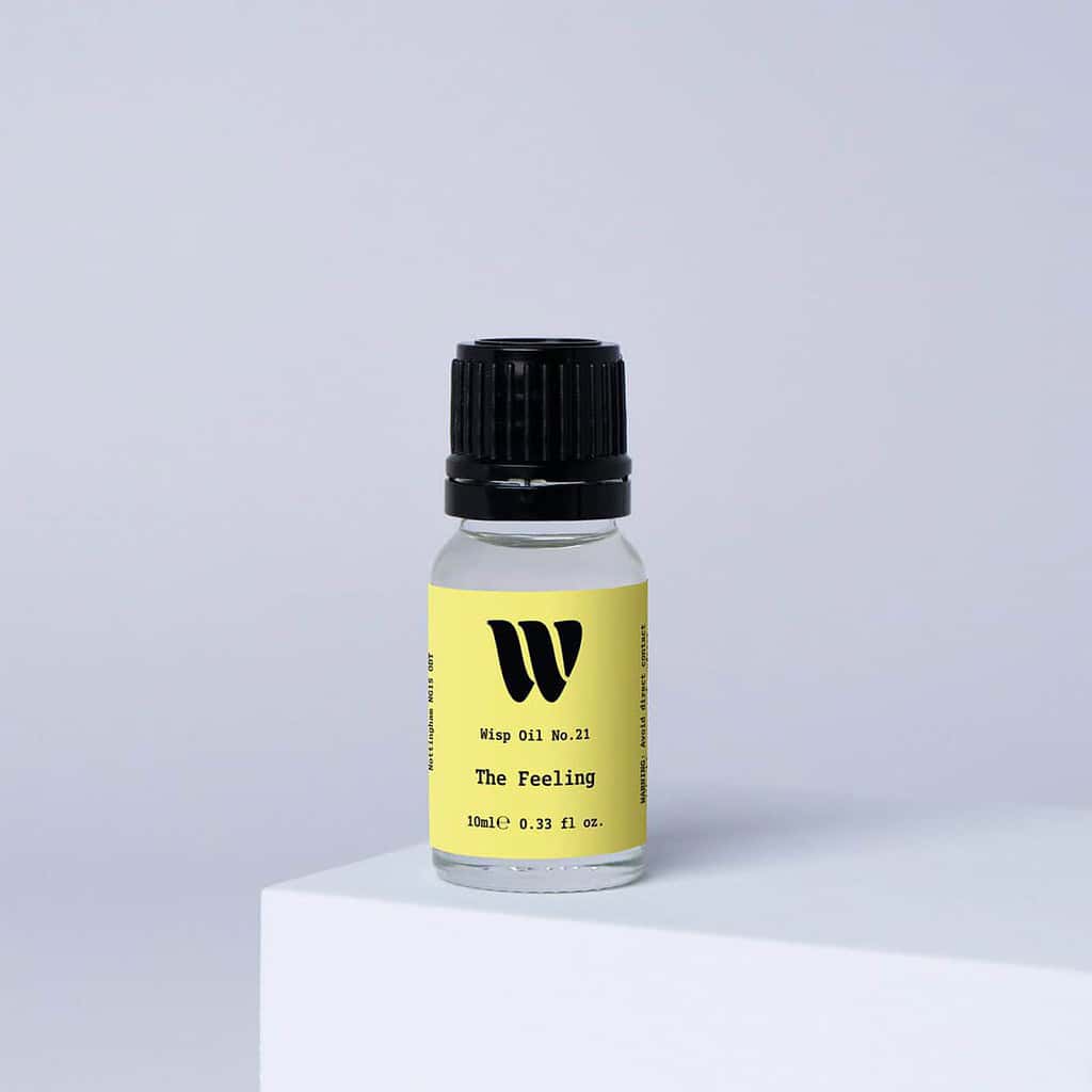 Bottle of the 10ml Wisp home fragrance oil No.21 The Feeling which has notes of blackcurrant berries and Bulgarian rose