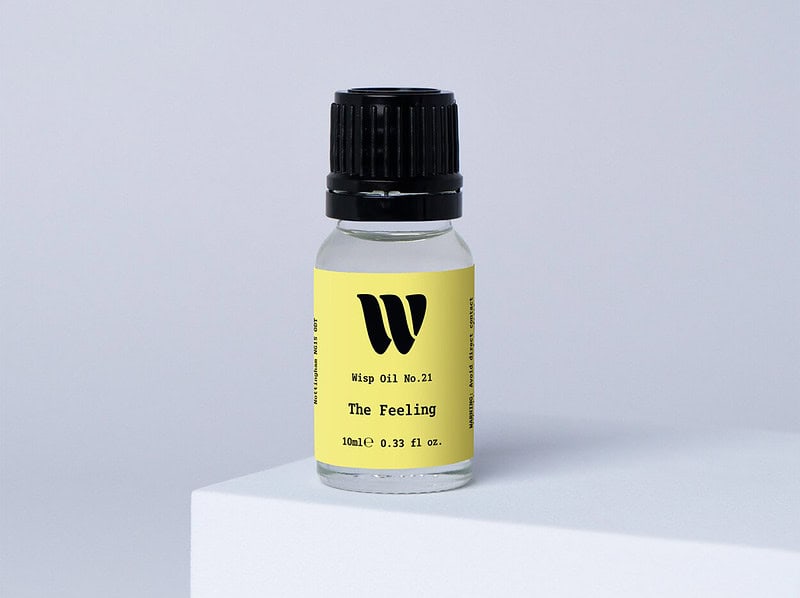 Bottle of the 10ml Wisp home fragrance oil No.21 The Feeling which has notes of blackcurrant berries and Bulgarian rose