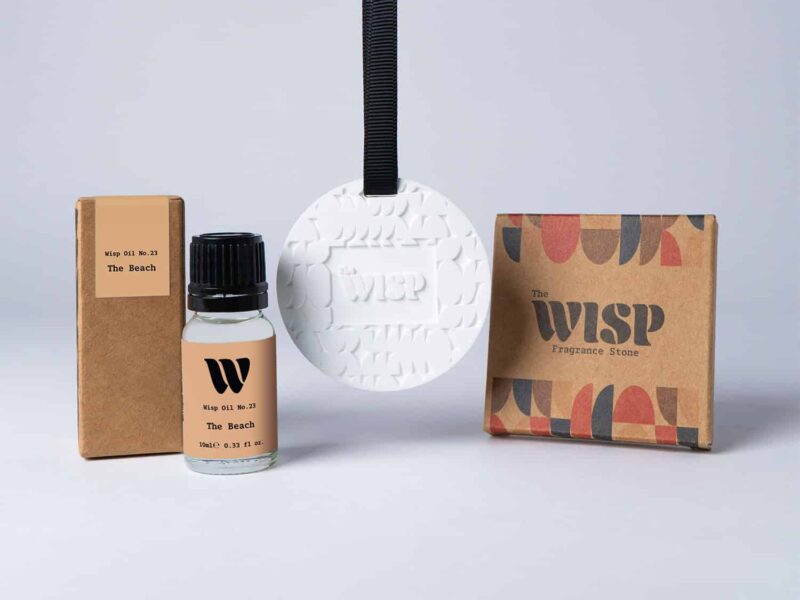 Bottle of the 10ml Wisp home fragrance oil No.23 The Beach which has notes of subtle spices, with a premium wisp branded fragrance stone to hang in car or wardrobe. The perfect small gift.
