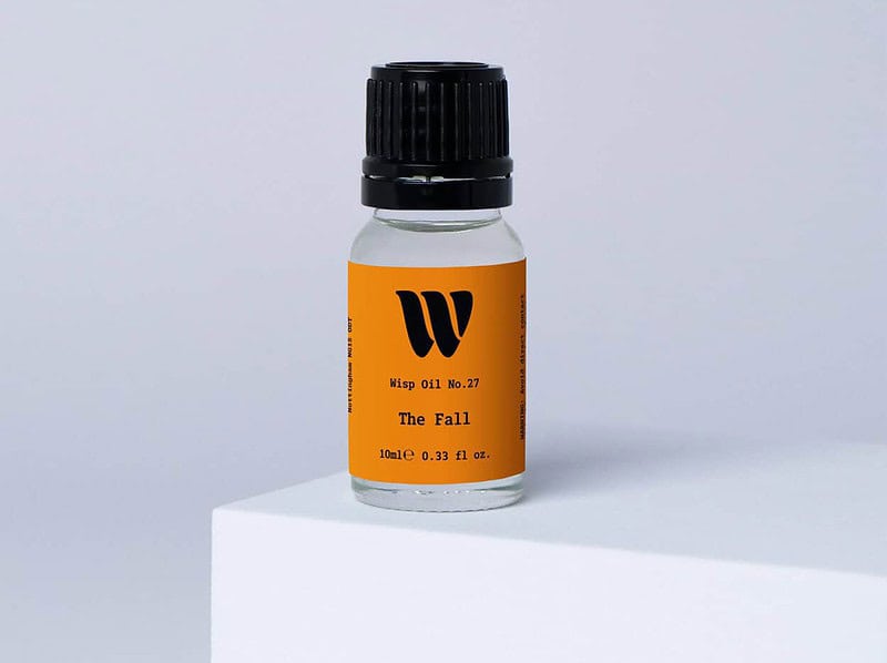 Bottle of the 10ml Wisp home fragrance oil No.27 The Fall which has notes of cedarwood, cardamom and pink pepper.