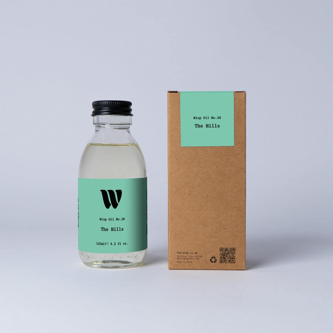 Bottle of the 125ml Wisp home fragrance oil No.28 The Hills which has notes of citrus, tea and cedarwood.