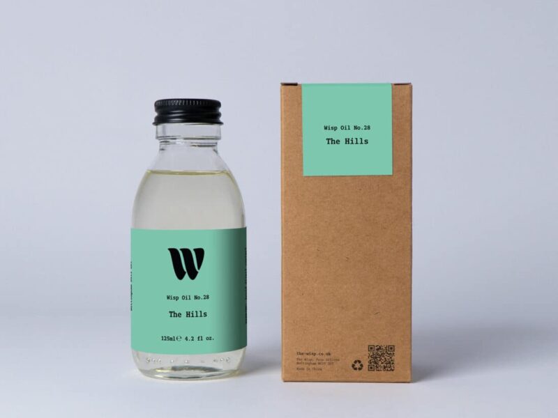 Bottle of the 125ml Wisp home fragrance oil No.28 The Hills which has notes of citrus, tea and cedarwood.