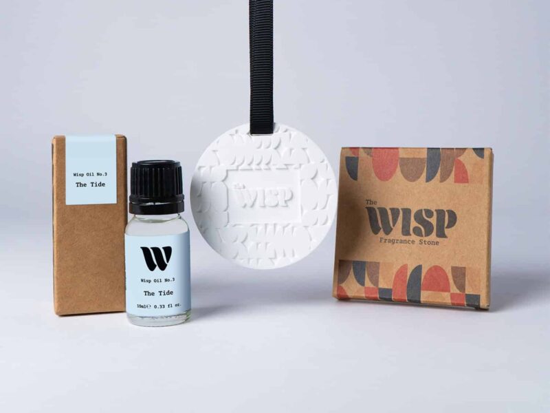 Bottle of the 10ml Wisp home fragrance oil No.3 The Tide which has notes of sea breeze, cucumber and crocus, with a premium wisp branded fragrance stone to hang in car or wardrobe. The perfect small gift.