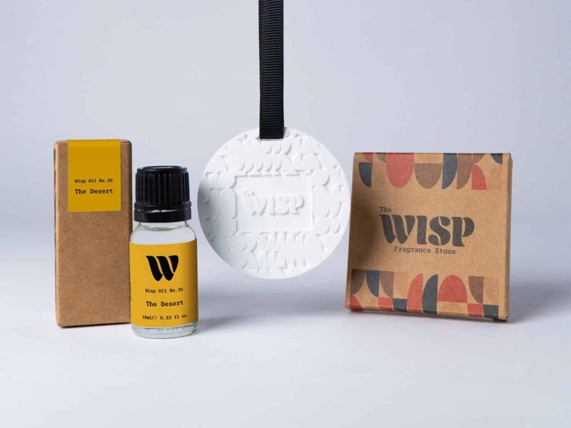 Bottle of the 10ml Wisp home fragrance oil No.30 The Desert which has notes of mandarin and Californian lemon, with a premium wisp branded fragrance stone to hang in car or wardrobe. The perfect small gift.