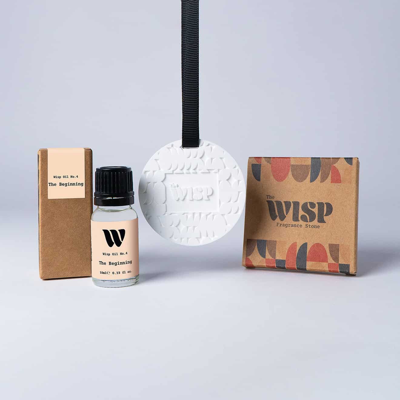 Bottle of the 10ml Wisp home fragrance oil No.4 The Beginning which has notes of sage, lemon and sea salt, with a premium wisp branded fragrance stone to hang in car or wardrobe. The perfect small gift.