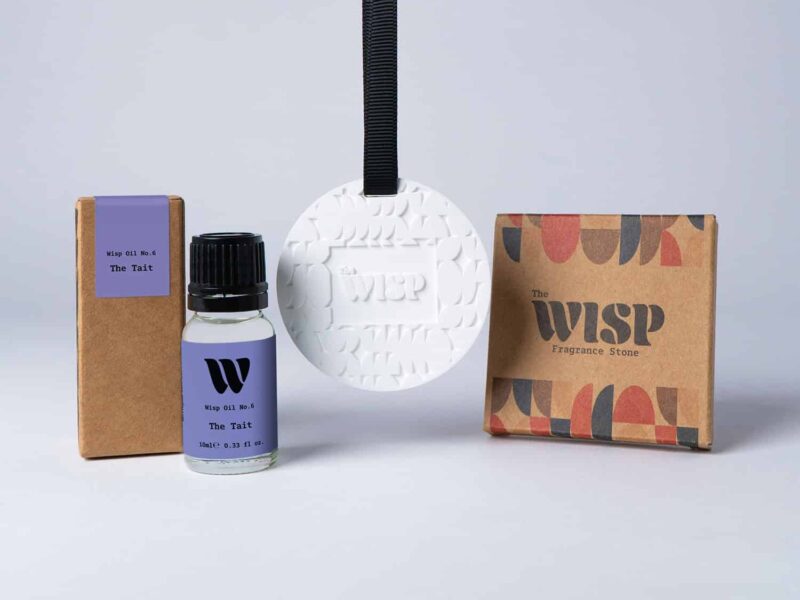 Bottle of the 10ml Wisp home fragrance oil No.6 The Tait which has notes of orange and grass, with a premium wisp branded fragrance stone to hang in car or wardrobe. The perfect small gift.