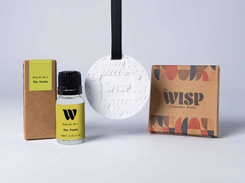 Bottle of the 10ml Wisp home fragrance oil No.7 The Panda which has notes of ylang-ylang, orange blossom, and bergamot, with a premium wisp branded fragrance stone to hang in car or wardrobe. The perfect small gift.