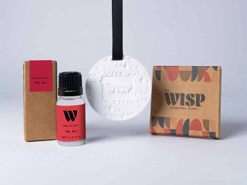 Bottle of the 10ml Wisp home fragrance oil No.8 The Ace which has notes of citrus, aromatic herbs, and florals, with a premium wisp branded fragrance stone to hang in car or wardrobe. The perfect small gift.